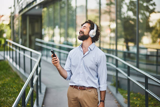 istock Cheerful entrepreneur enjoying music during his work break 2221440220