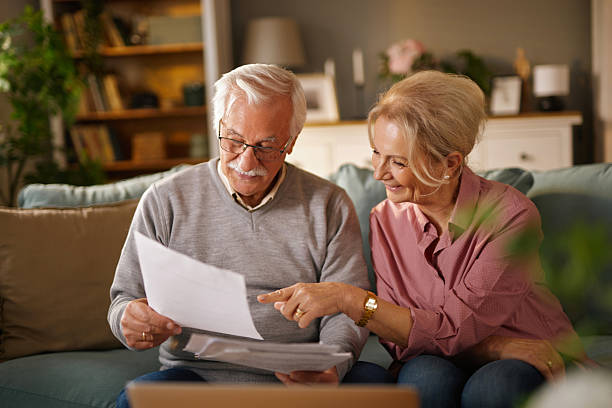 istock Senior couple reading documents at home, planning their future 2221441514