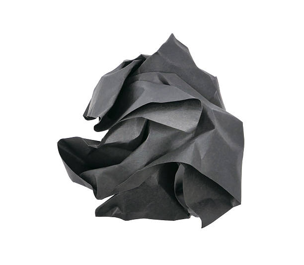 istock Crumpled black paper ball isolated on white background 2221443094