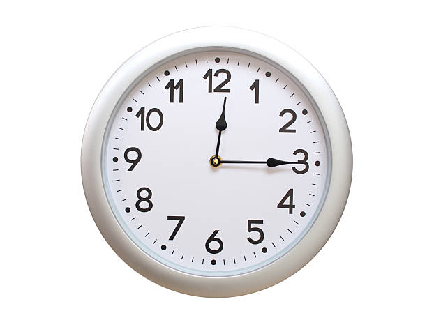 Wall clock with a blue face and white frame showing exactly 00:15 or 12:15. Represents time, deadlines.