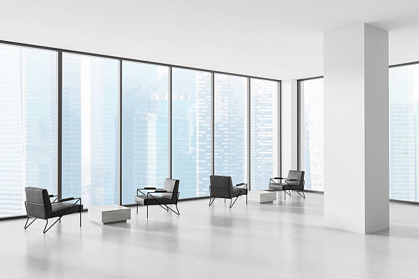 istock Modern office interior with minimalist lounge area and large panoramic windows overlooking city skyline in daylight. 3D Rendering 2221443660