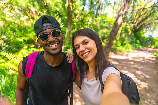 istock Hikers taking a selfie while walking in the forest 2221444871