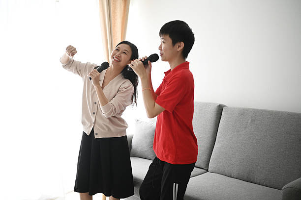 istock Mother and child dancing and singing at home 2221448703