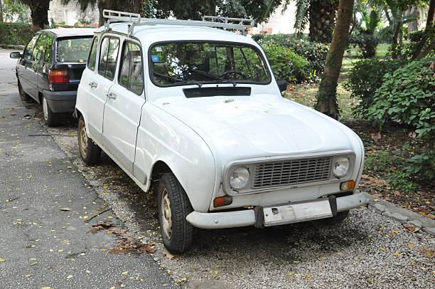 istock White Classic Car Parked on Leafy Urban Road 2221449366