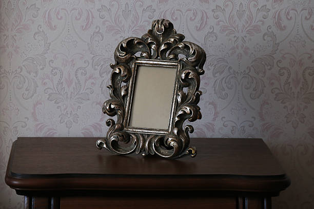 istock Ornate frame on dark wood with wallpaper background. Luxurious Desktop Ornament. 2221451821