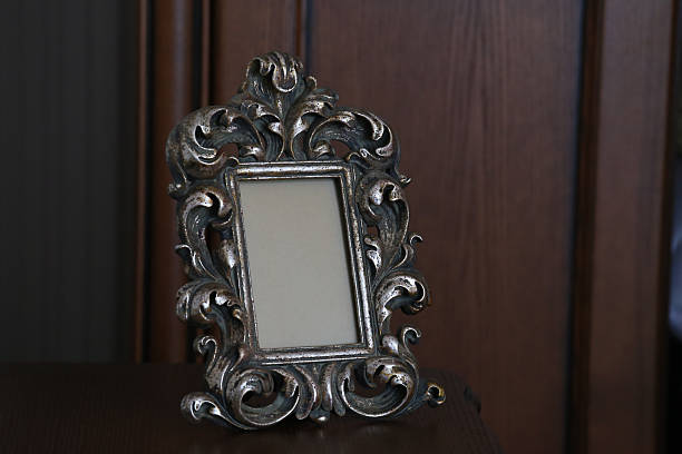 istock Ornate Vintage Silver Picture Frame with Empty Space on Dark Wooden Background 2221451822
