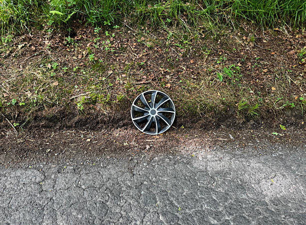 Single hubcap for a car left on the side of a rural country road in Somerset. June 2025