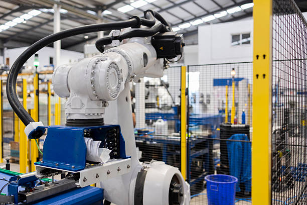 istock Robotic arm handling material on assembly line in factory 2221460192
