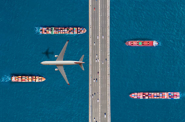 istock Aerial view of a cargo ship passing under bridge. Cargo Ship Beneath Bridge. 2221464063