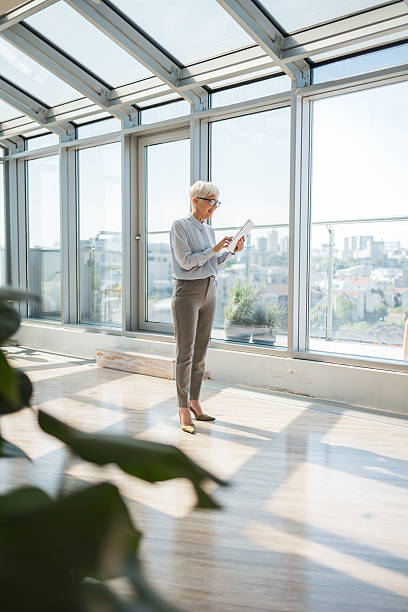 istock Professional woman working with digital tablet in a modern office setting 2221467427