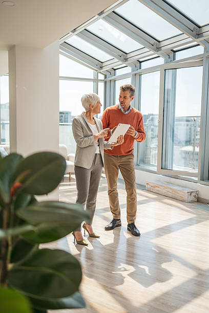 istock Two business professionals discuss a project in a modern office setting 2221467459