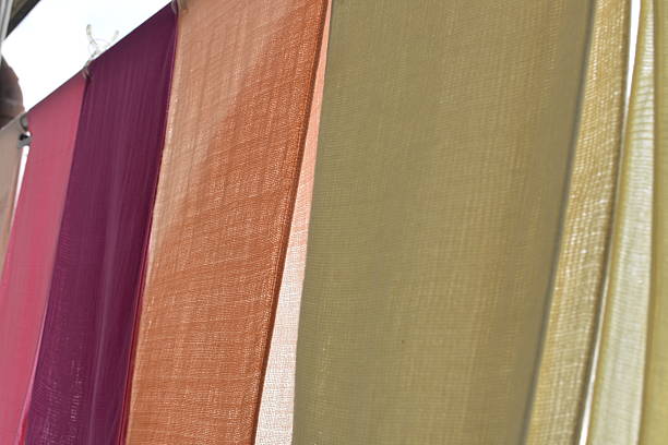 Close-up of colorful laundry hanging on a balcony,\nseasonal clothing changes