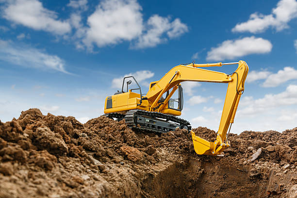 istock Excavator with bucket lift up  are digging  soil in the construction site . 2221471595