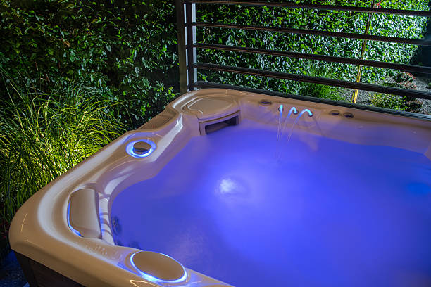 Relaxation Oasis Featuring a Illuminated Hot Tub in a Serene Garden Setting During Evening Hours