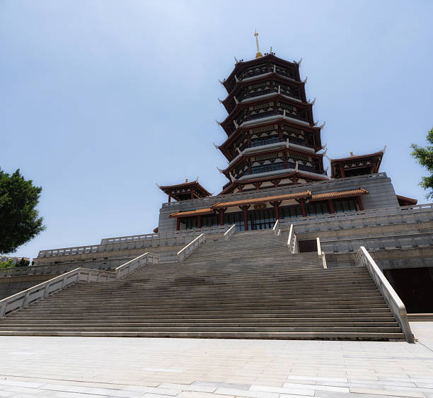 Incheon, South Korea - May 19th 2025: A traditional red-and-green staircase beneath Suhyangwon Pavilion leads to the second-floor viewing area, supported by sturdy stone pillars along the Ara Waterway.