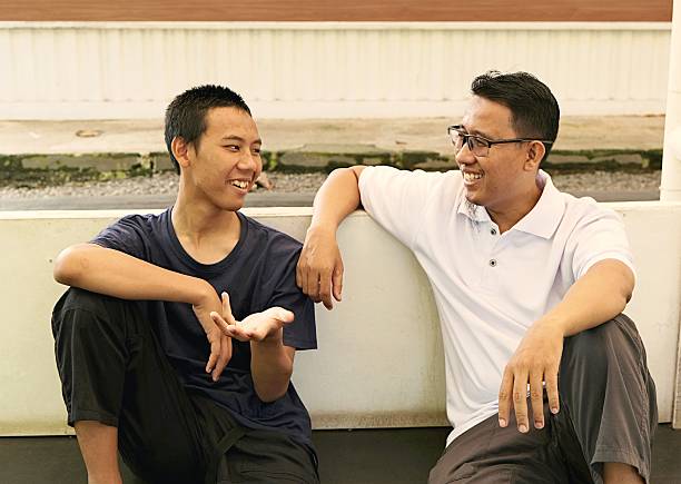 istock Laughing Together: Father and Teenage Son 2221478067