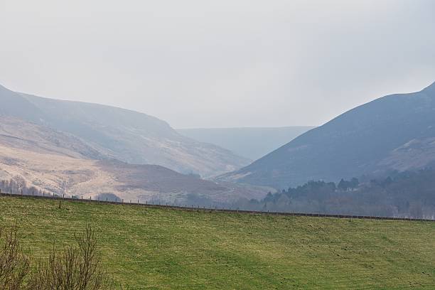 istock A verdant field sits beneath hazy mountains. 2221478455