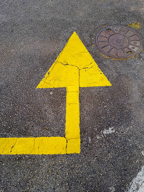istock Yellow arrow painted on the asphalt. 2221478636