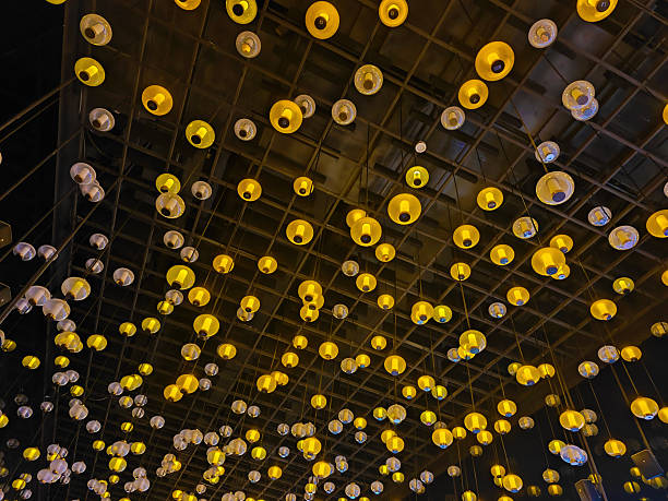 groups of different yellow bulbs hang on the roof