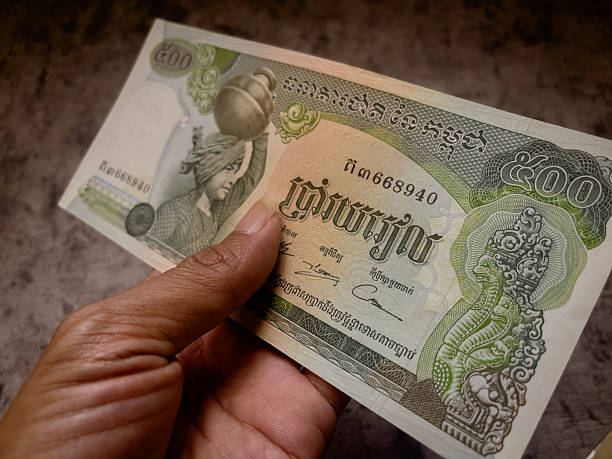 istock Hand holds a cambodian 500 riel banknote. 2221485286