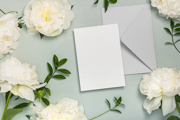 istock Invitation or greeting card mockup with envelope and white peony flowers. 2221487981