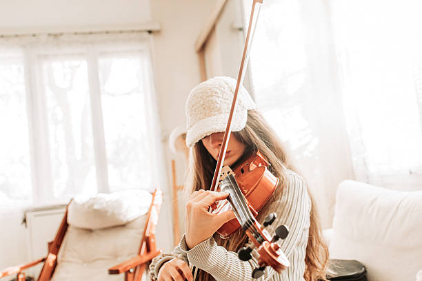 istock Young brunette girl play a violin at home, practice 2221488192