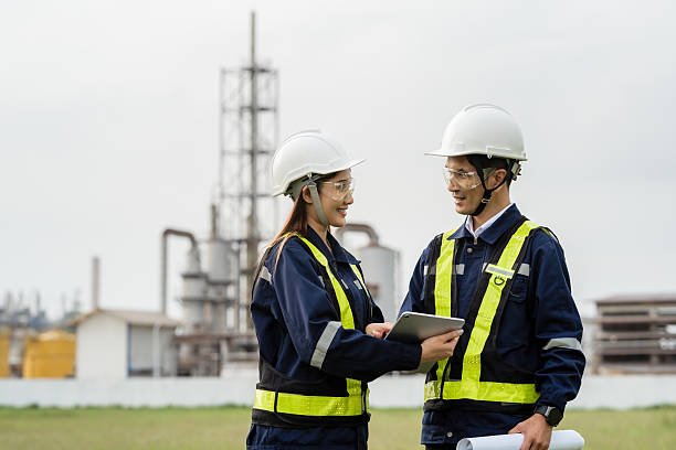 istock Two Professional Engineers Discussing Project Details on a Tablet. Two people wearing safety gear and holding a tablet 2221489073