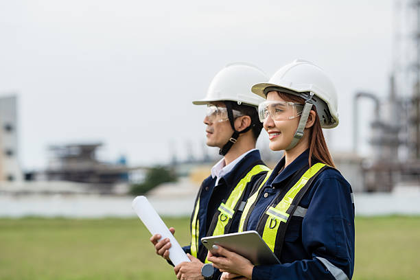 istock Engineering Team Looking Towards the Future with a Shared Vision. Two people wearing safety gear and holding papers 2221489093