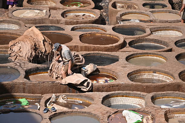 Fes, Morocco - April 23, 2025 - Workers in Chouara tannery, the largest and one of the oldest tanneries in Fes