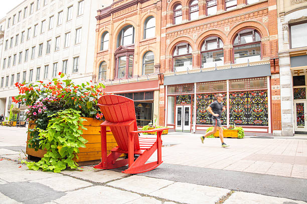 Ottawa, Canada - September, 24, 2024:  Sunday runner passing by the giat seat in the famous Sparks St. in Ottawa. Long exposure.