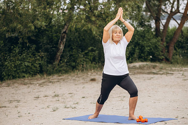 istock Senior Woman Practicing Yoga Outdoors on a Mat in a Peaceful Park Setting 2221490832