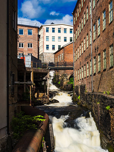 istock Waterfall flows through old industrial buildings in Molndal, Sweden, capturing the blend of nature and history 2221492844