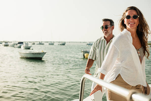 Happy couple enjoying a sunny day on a boat