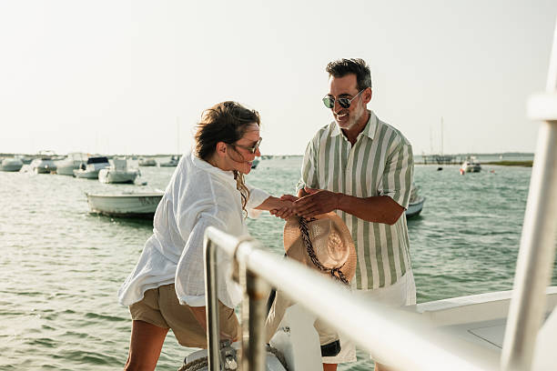 istock Couple boarding sailboat on sunny summer day 2221493165