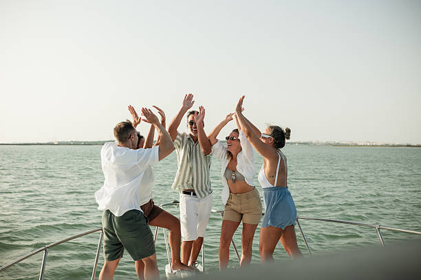 istock Friends cheering on a boat trip during summer vacation 2221493807
