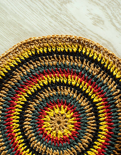 istock Beautiful crochet pattern made of raffia on a wooden background. 2221495298