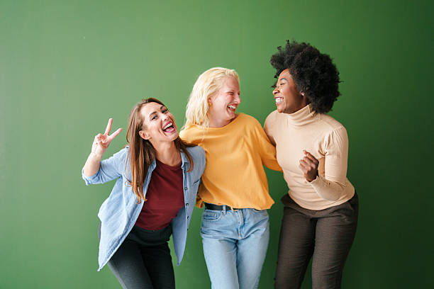 istock Multicultural Friends Laughing Together Against Green Background In Studio Lighting 2221495654