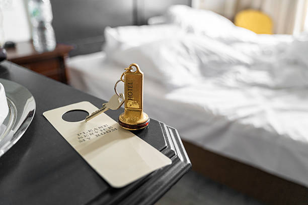 A hotel room key and tag on a nightstand symbolize the essence of hospitality and comfort for guests