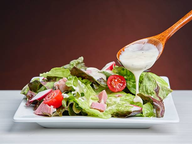 istock Putting dressing on a delicious salad. 2221500581