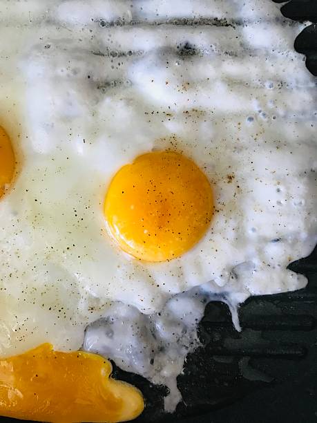 Cooking sunny side up eggs on a stove in a cozy kitchen