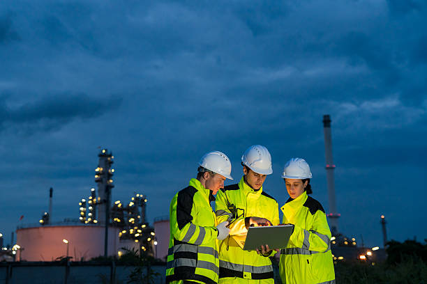 istock Engineering team collaborating with a laptop during a night shift at a petrochemical refinery. 2221508184