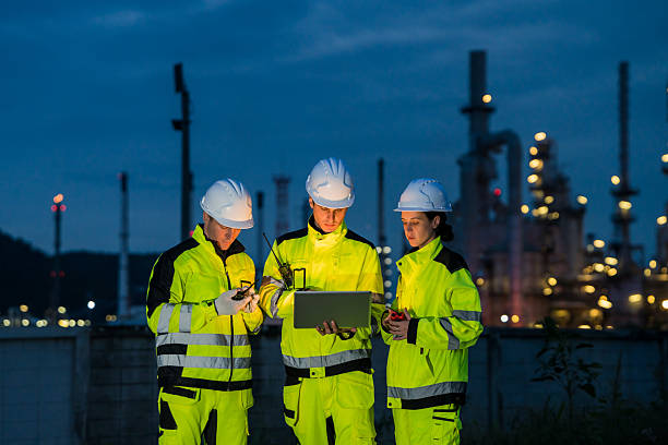 istock Engineering team collaborating with a laptop during a night shift at a petrochemical refinery. 2221508185