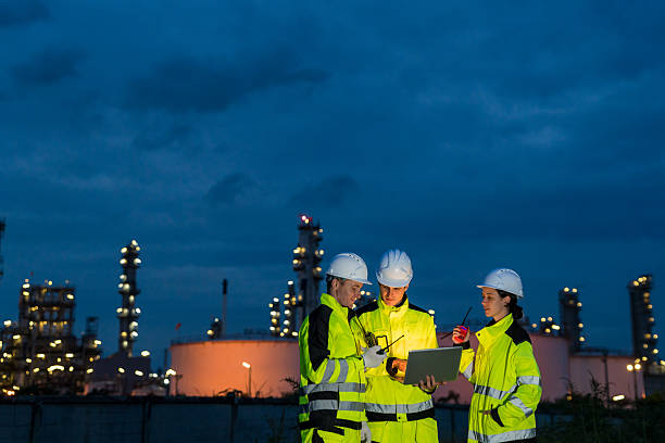 istock Engineering team collaborating with a laptop during a night shift at a petrochemical refinery. 2221508188