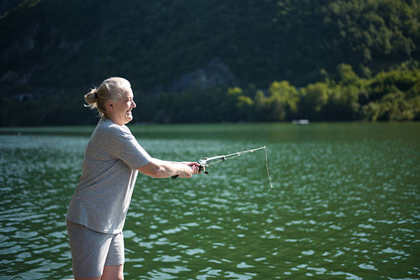 Middle age woman fishing in the lake