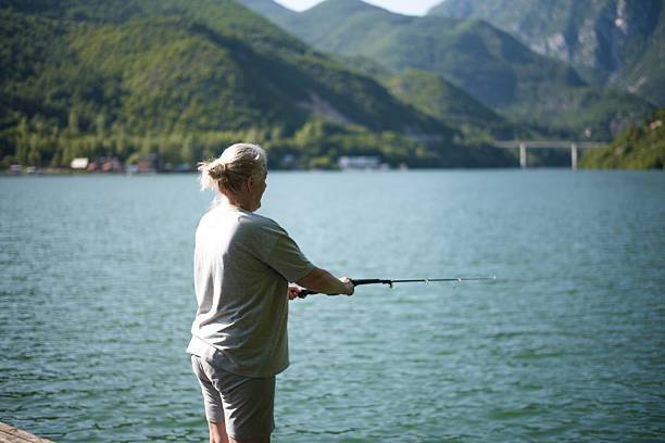Middle age woman fishing in the lake