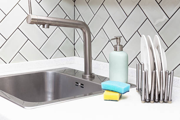 istock Clean kitchen sink with clean stacked plated and soap dispenser 2221510377