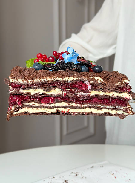 istock Layered Chocolate Berry Cake Slice with Botanical Garnish 2221516015