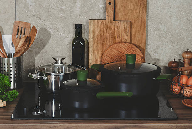 istock Bright kitchen with countertop, showcasing artisan cookware on induction oven for preparing nutritious meals at home. 2221516192