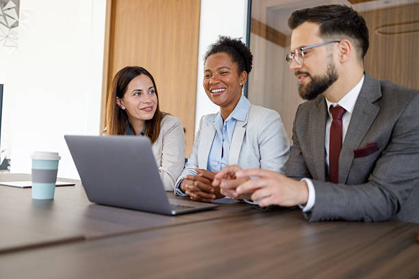 istock Three businesspeople are working together in a modern office, using a laptop to collaborate on a project 2221518217