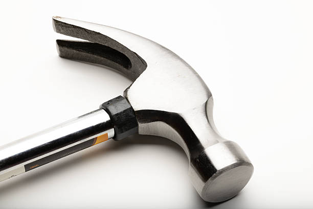 istock A close-up of a metallic hammer with a smooth handle and a shiny head. The hammer features a claw for pulling nails and is designed for construction tasks. 2221521073